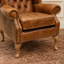 Close up of the deep buttoned seat and antique studding on the Queen Anne armchair