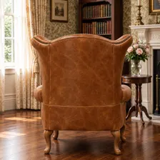Queen Anne wingback armchair in tan vintage leather, angled rear view