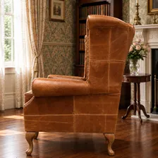 Queen Anne wingback armchair in tan vintage leather, side profile